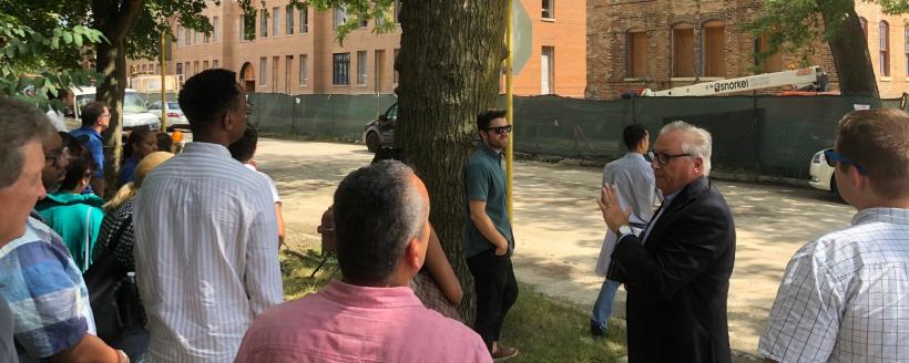 Dave Doig, President of Chicago Neighborhood Initiatives, showing visitors the Artist Residence program within Invest South West.